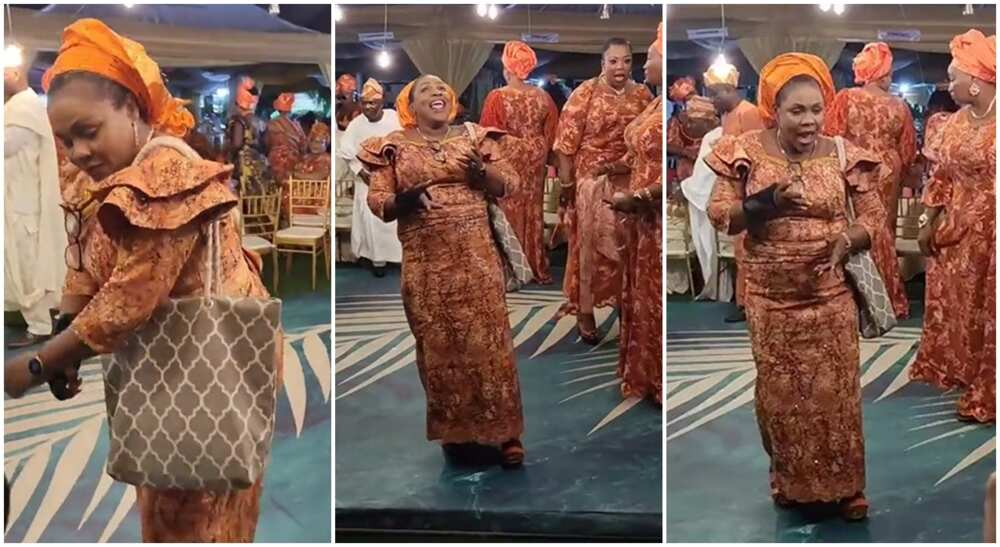 Nigerian woman in beautiful wrapper entertains wedding guests with sweet dance moves.