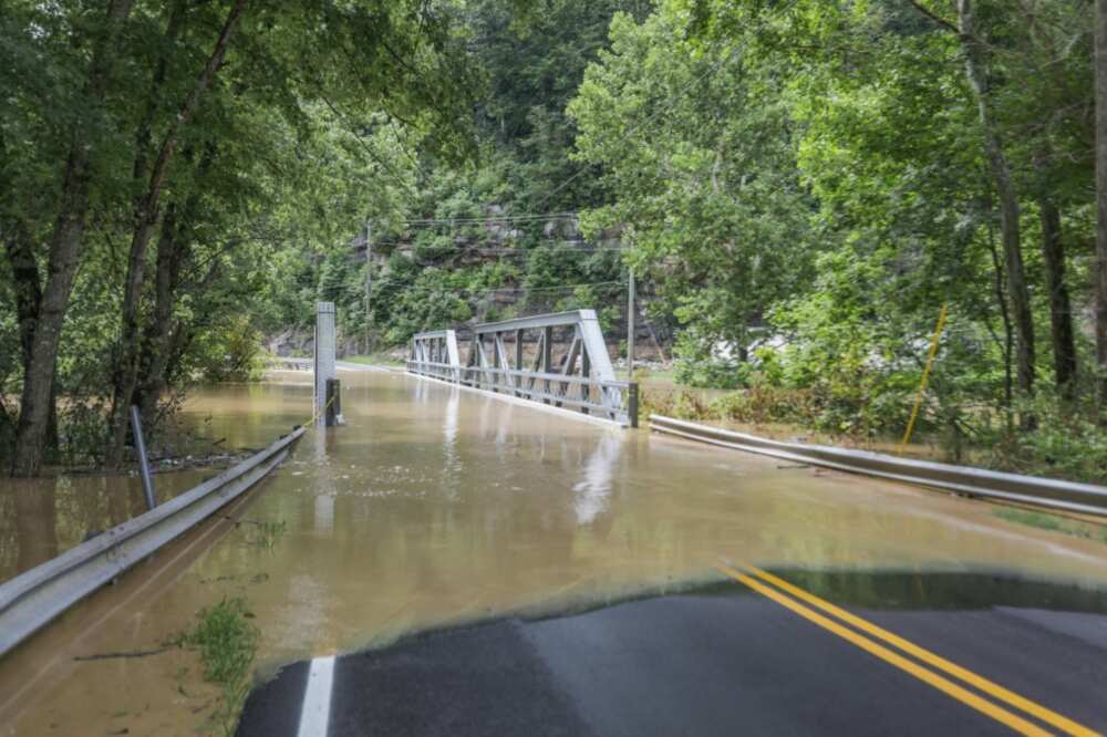 A bridge and a road are submerged by floodwaters from the North Fork of the Kentucky River in Jackson, Kentucky
