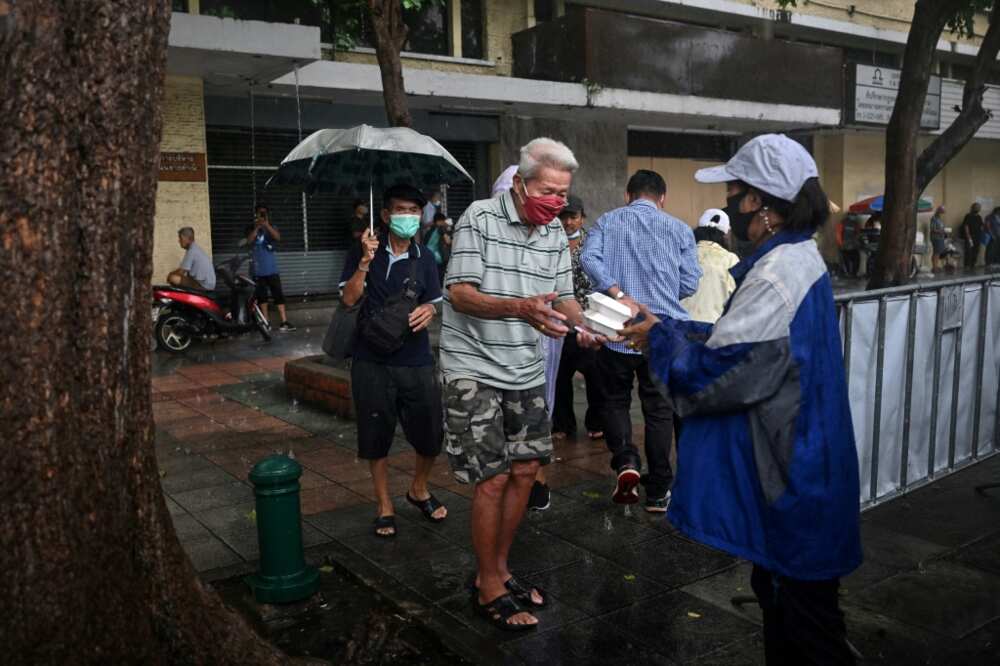 Volunteers from Bangkok Community Help Foundation give out free meals in the Thai capital