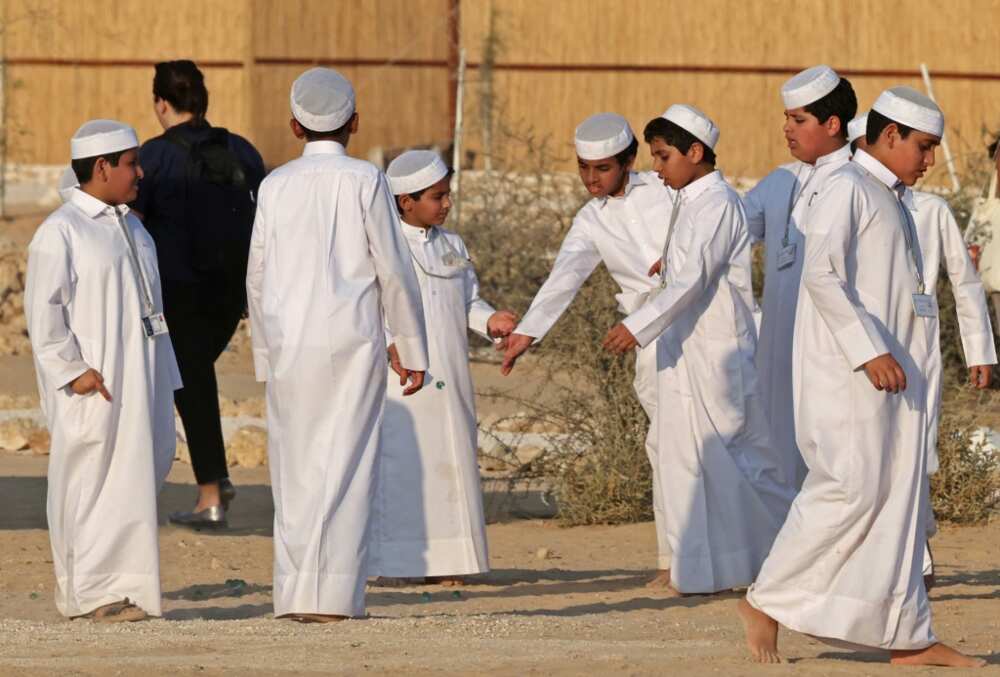 Qatari boys wear the traditional garment known as the thobe