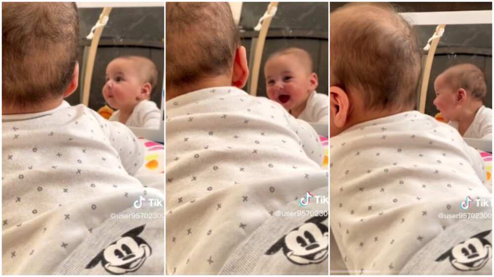 baby laughs hard after seeing self in mirror