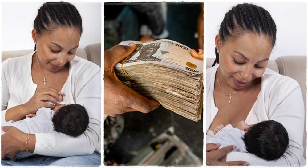 Woman looking at phone while holding baby.