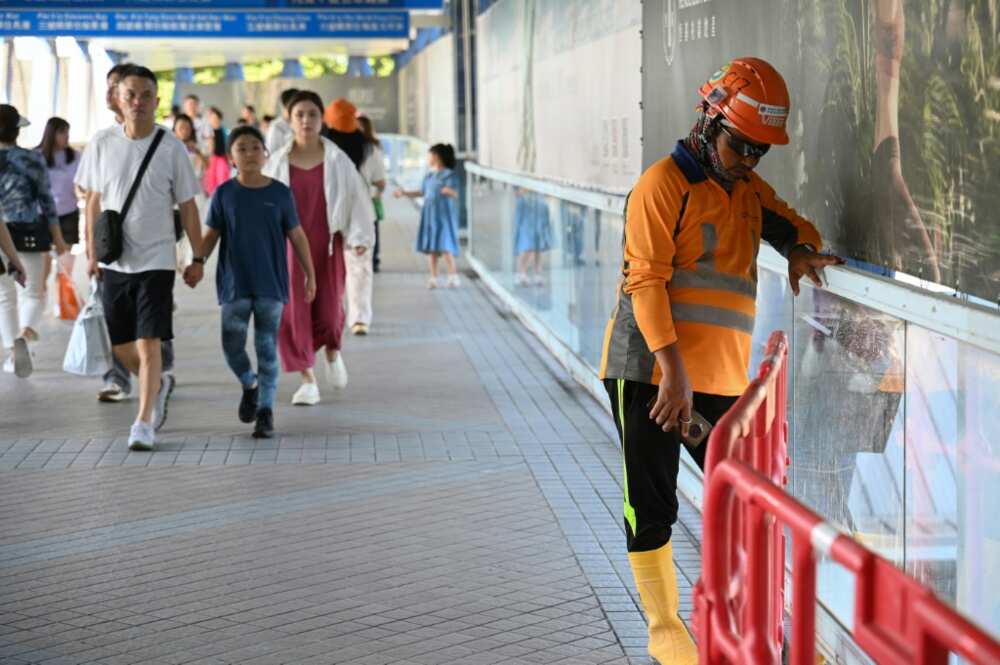 A Hong Kong construction worker (R) takes a break from the heat
