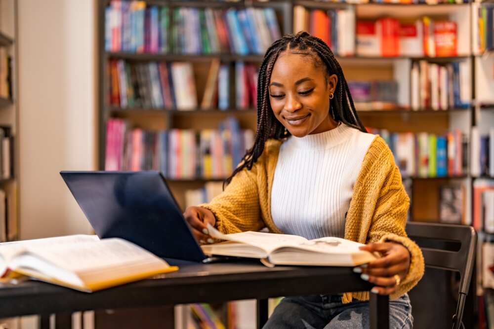 A young lady studying in a library