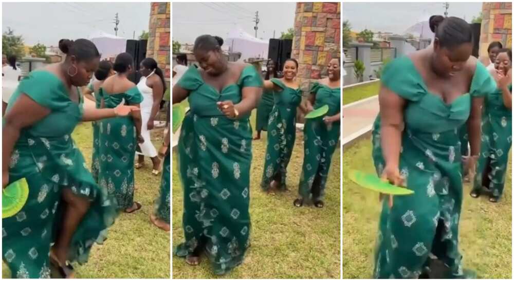 Lady in green gown showcasing nice dance steps in public surrounded by other ladies.
