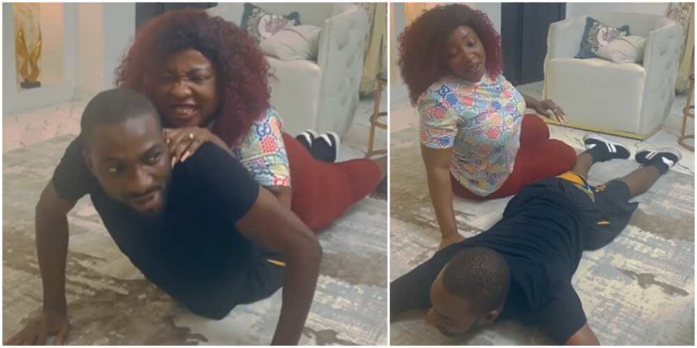 Anita Joseph almost breaks her husband's back as she lies on him during press-up exercise Anita Joseph almost breaks her husband's back as she lies on him during press-up exercise