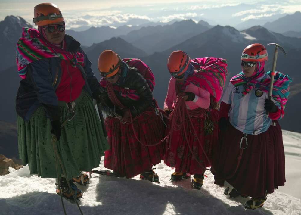 (Left-right) Adela Llusco, Senobia Llusco, Cecilia Llusco and Camila Tarqui Llusco, Aymara indigenous women members of the Climbing Cholitas of Bolivia Warmis, at the summit of the 6.088-metre Huayna Potosi mountain