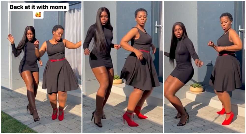 Young black mum dances with her grown daughter.