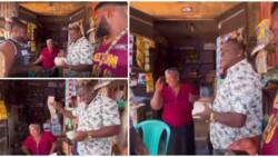 Nigerian singer remembers seller who gave him akara on credit when he's broke, rains cash in her shop in video