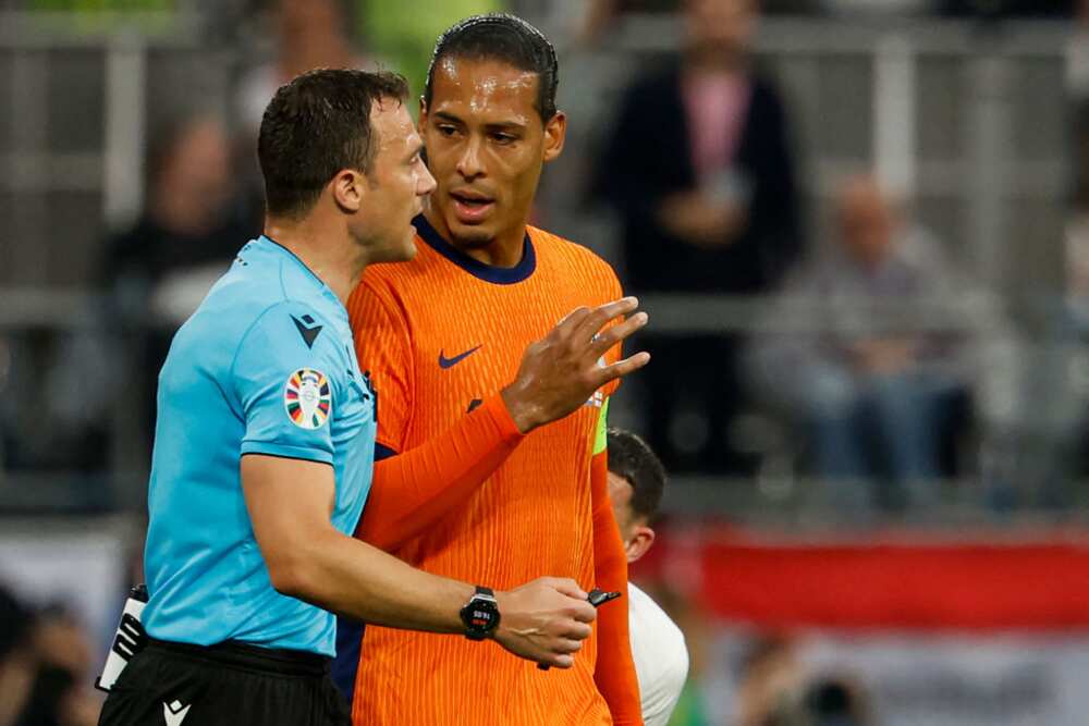 Virgil Van Dijk talks to Felix Zwayer during Euro 2024 semi-final between the Netherlands and England