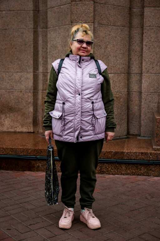 Pensioner Svitlana, 62, says khaki matches the current political climate  -- though she tops her outfit off with a candy-pink down jacket