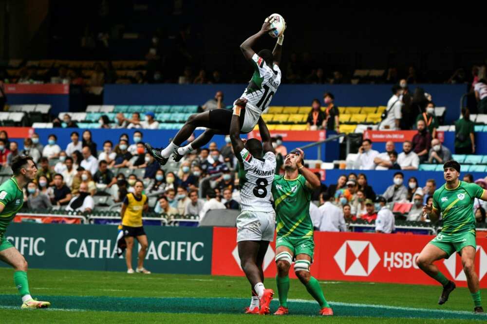 Kenya's Johnstone Olindi (top) is lifted by teammate Herman Humwa (C) against Ireland in the Hong Kong Sevens rugby tournament on November 4, 2022.