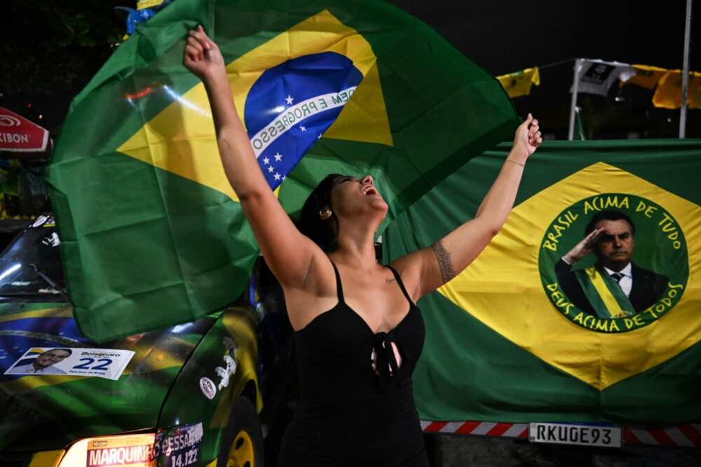 A supporter of far-right President Jair Bolsonaro waving the flag on election day