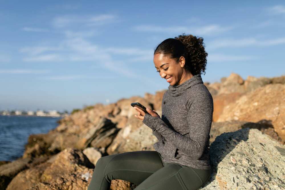 A happy woman using a smartphone