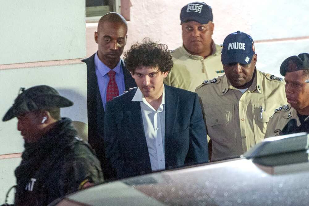 FTX founder Sam Bankman-Fried is led away handcuffed by police in Nassau, Bahamas on December 13, 2022