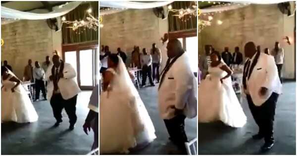Happy bride and her plus-sized groom rock the dance floor as crowd cheer them on