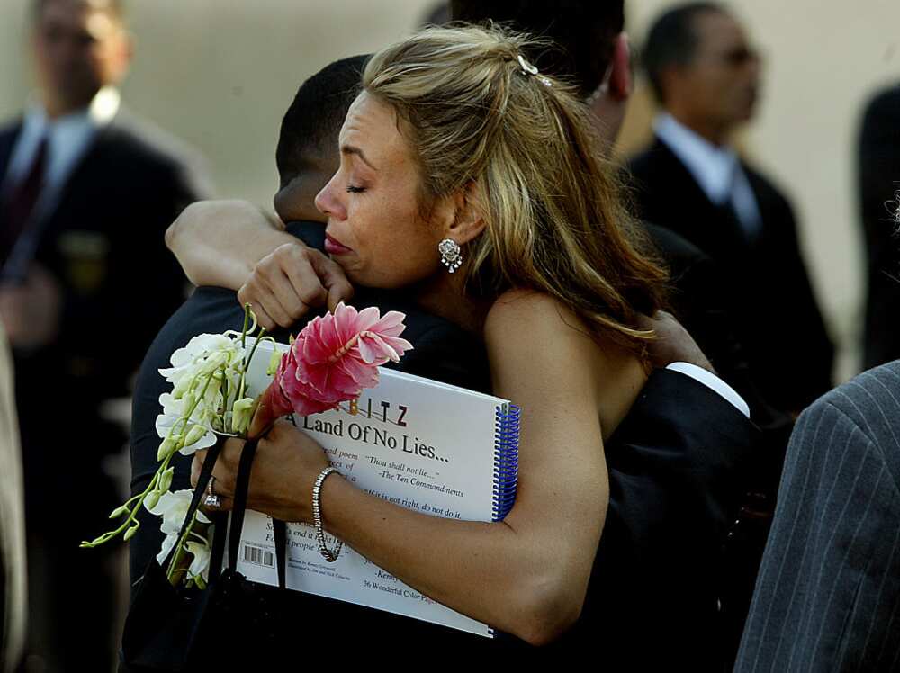 Tanya Hijazi gets a hug during Rick James' burial