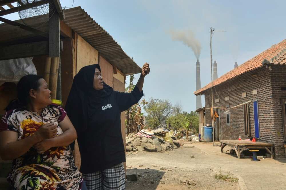 Local residents talk about air pollution during an interview with AFP near the Suralaya coal-fired power plant in Cilegon, in Indonesia's Banten province