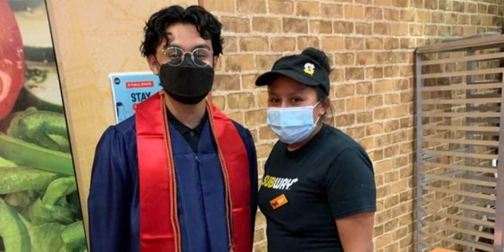 The young graduate posed for a photo with the kindhearted woman who fed him in school