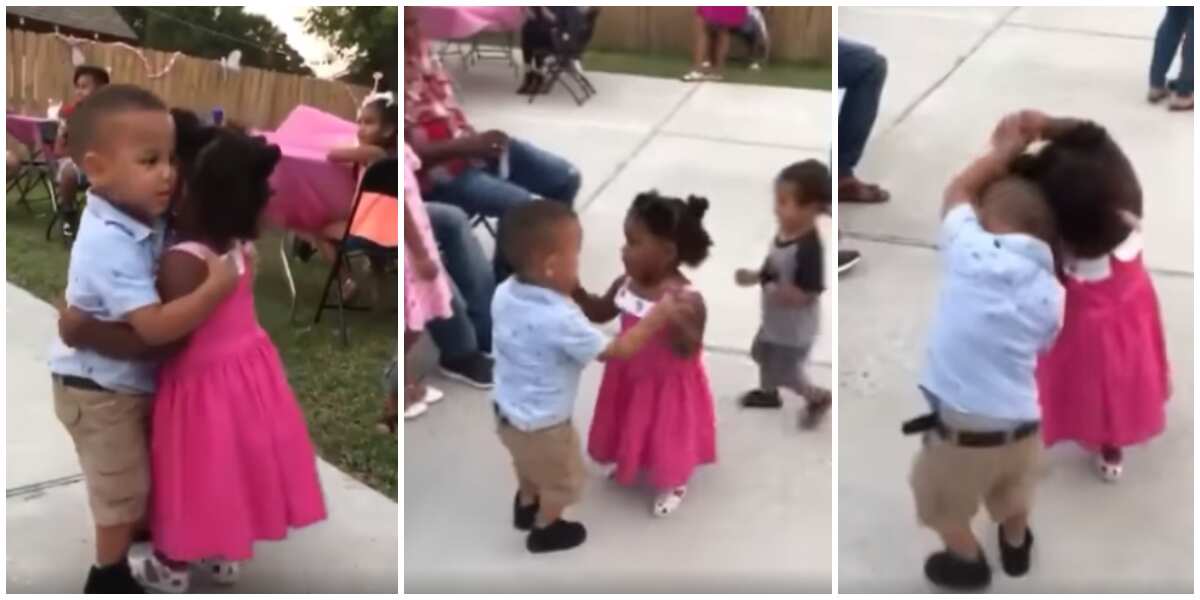 Little girl and boy hold hands and hug tightly as they dance like perfect couple before adults in cute video