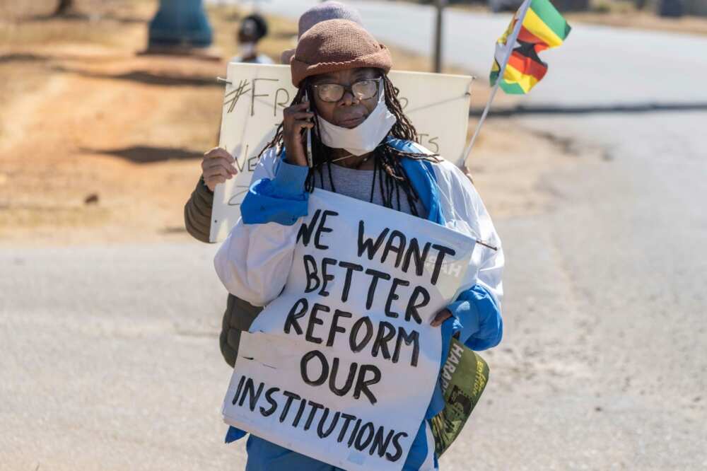 Writer Tsitsi Dangarembga was arrested for holding up a  placard during a roadside protest with her neighbour in July 2020