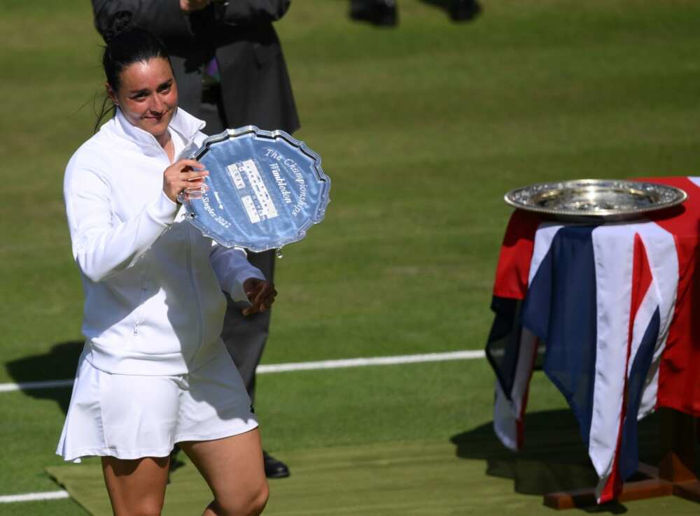 Tunisia's Ons Jabeur celebrates shows her runner-up trophy during the podium ceremony after losing against Kazakhstan's Elena Rybakina in their women's singles final at Wimbledon