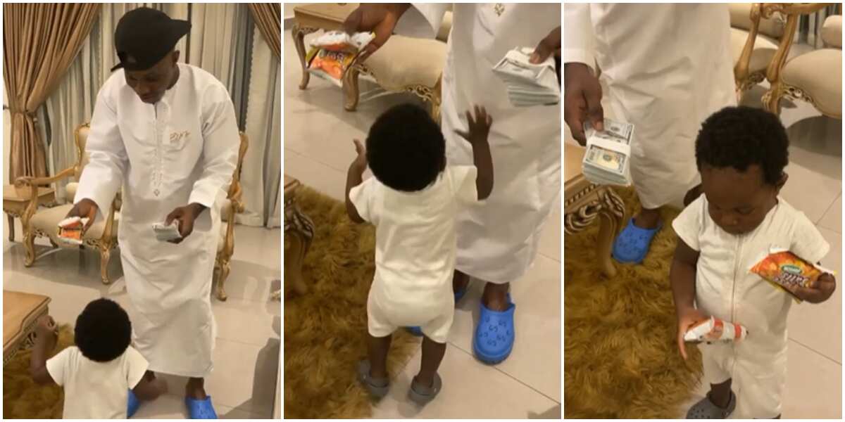 Zlatan Ibile disappointed as his 1-year-old son picks cheese balls over dollars in video, calls him 'omo ase'