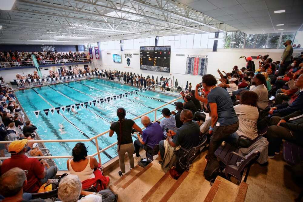 Some spectators stand to encourage Howard University swimmers at a recent meet that was the most attended aquatics competition in school history
