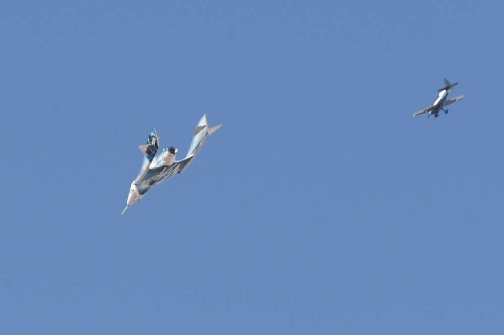 The Virgin Galactic SpaceShipTwo spaceplane Unity and mothership separate as they fly way above Spaceport America in New Mexico in July 2021 on the way to the cosmos