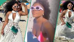 "You sef don go do BBL?" Fans react as Destiny Etiko flaunts body in viral beach dress, clips trend