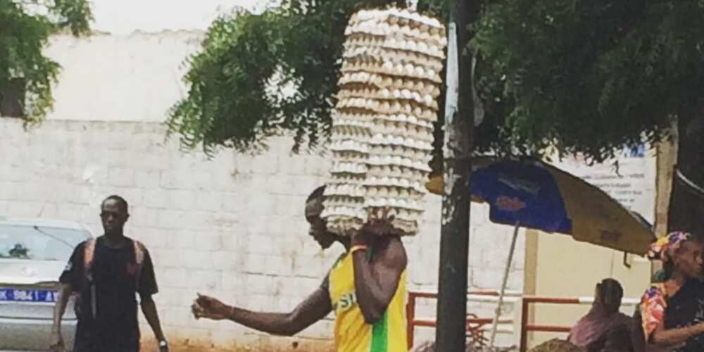 Man Shows Incredible Strength & Skill as He Walks on Wet Ground While Carrying Loads of Eggs on One Arm