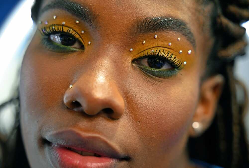 A fan of Brazil poses for a picture at a make up booth after watching the live broadcast of the Qatar 2022 World Cup Group G football match between Brazil and Switzerland at a music and football broadcast festival Rio de Janeiro, Brazil, on November 28, 2022