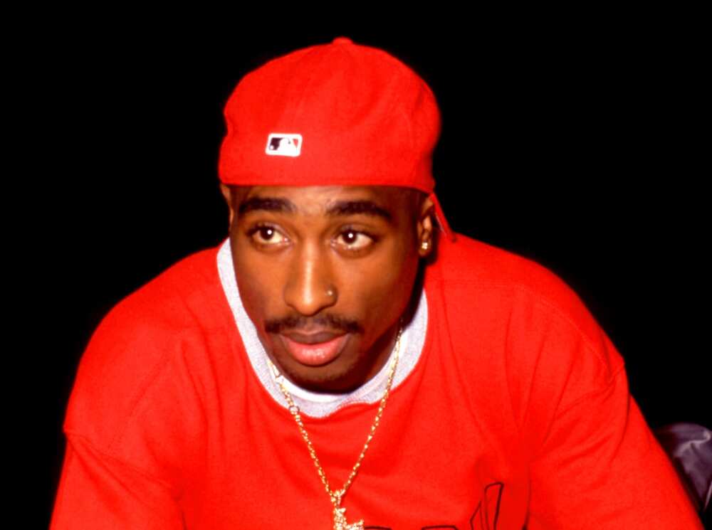 American rapper, songwriter, and actor (1971-1996) Tupac Shakur poses for a photo in a red and white outfit