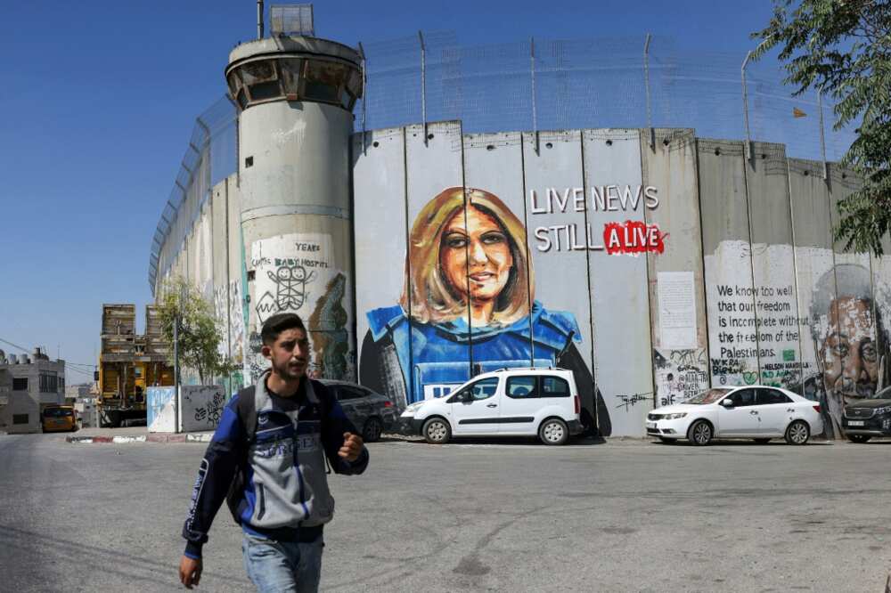 US-Palestinian ties have been strained by the killing of Al Jazeera reporter Shireen Abu Akleh, depicted here in a mural on Israel's controversial barrier