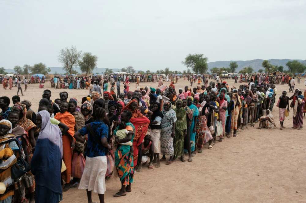 People line up to register for potential food aid delivery at a camp for internally displaced persons in Agari, South Kordofan, on June 17, 2024