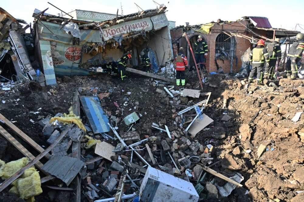Ukrainian rescuers at the site of a Russian missile strike in Kharkiv
