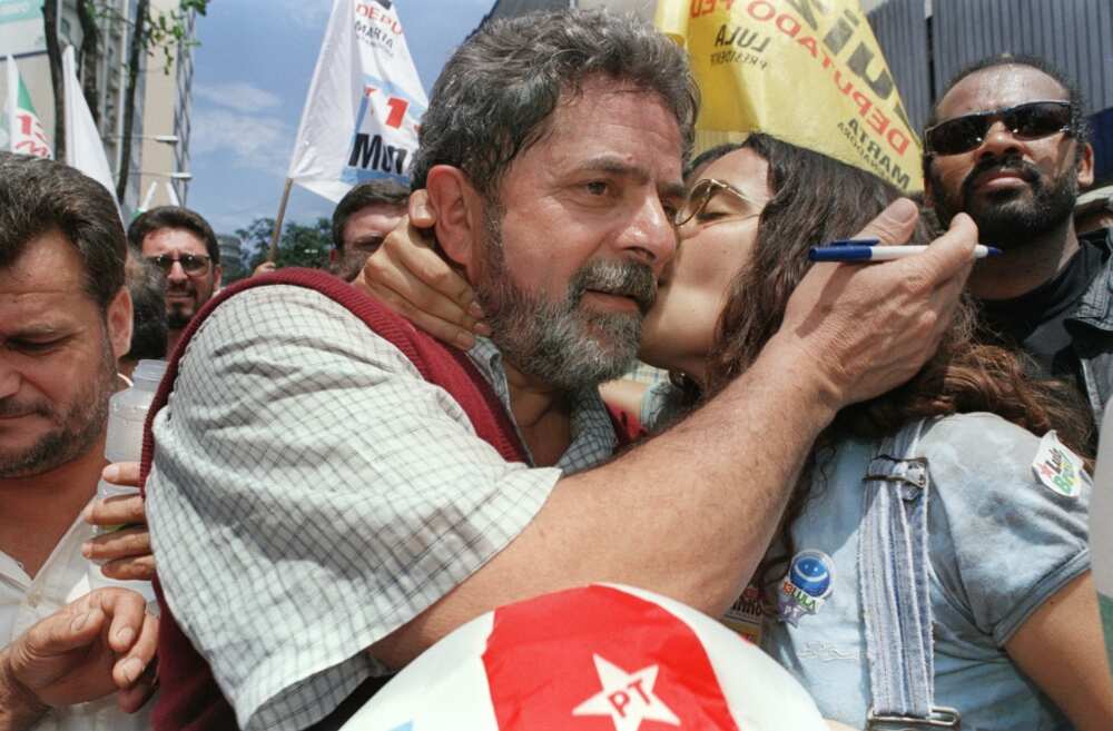 Brazilian presidential candidate Luiz Inacio Lula da Silva (L) is kissed in October 1998 by a supporter during a rally in Santo Andre, near Sao Paulo, Brazil