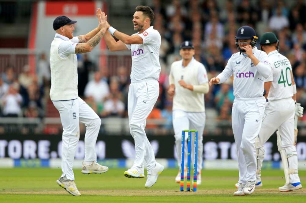 Early blow - James Anderson (2nd L) celebrates with England captain Ben Stokes (L) after dismissing South Africa opener Sarel Erwee in the second Test at Old Trafford
