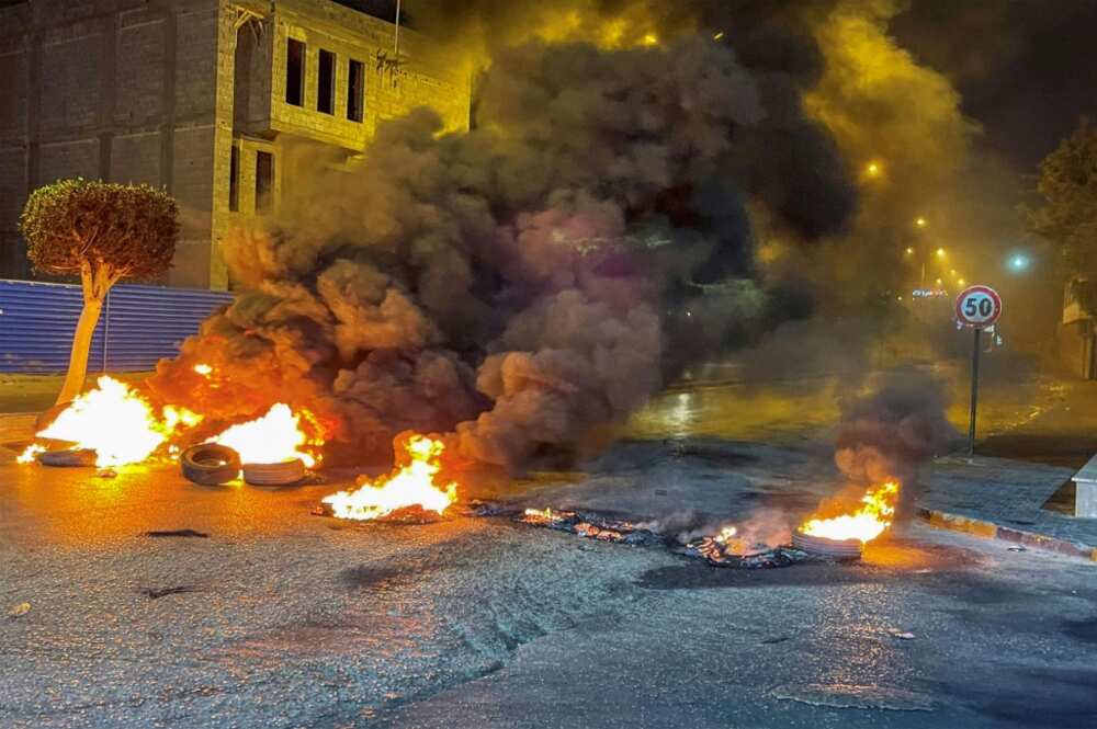 Protesters burnt car tyres to block roads in the Libyan capital Tripoli on July 4, 2022