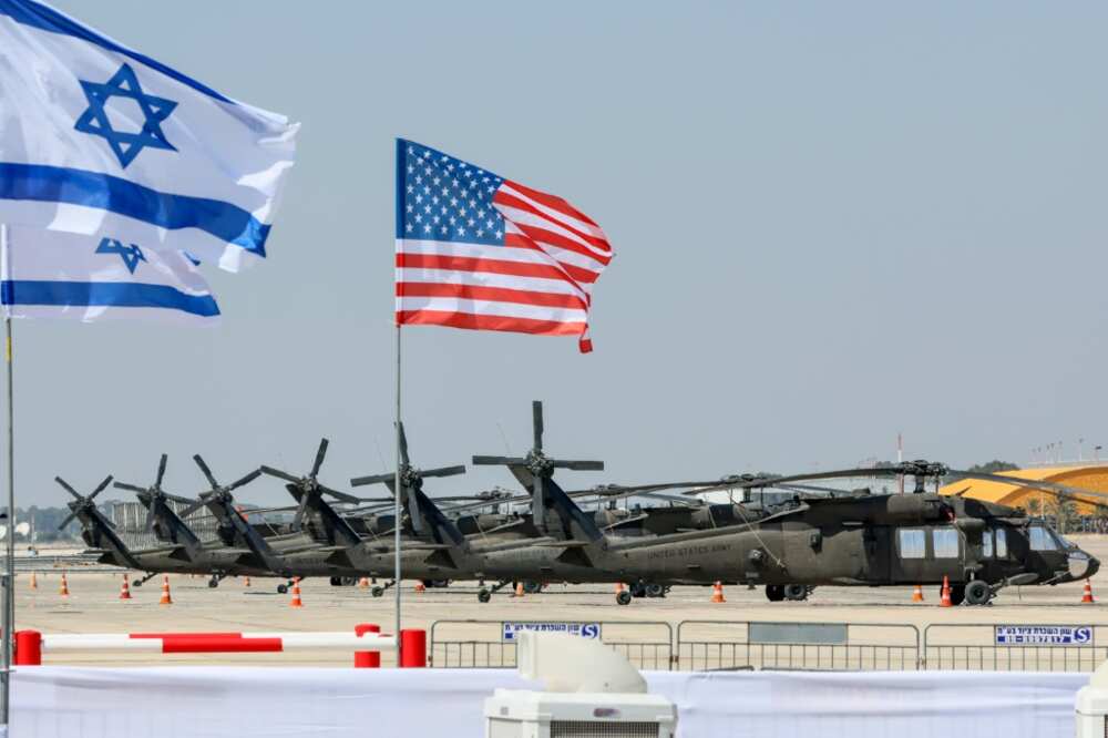 Military helicopters -- and the Israeli and US flags -- are pictured at Israel's Ben Gurion Airport ahead of US President Joe Biden's visit