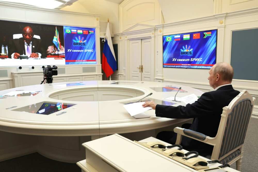 Putin, seen here in a picture distributed by the Russian news agency Sputnik, joined the summit by video link