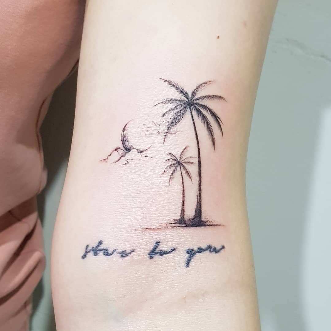 Fine line palm tree tattoo on the right inner forearm