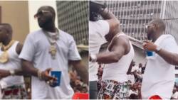 Davido takes US rapper DaBaby to Lagos trenches with huge crowd for their music video shoot, Nigerians react