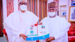 2023: Photos of Yahaya Bello presenting APC form before Buhari in Aso Rock sparks mix reactions