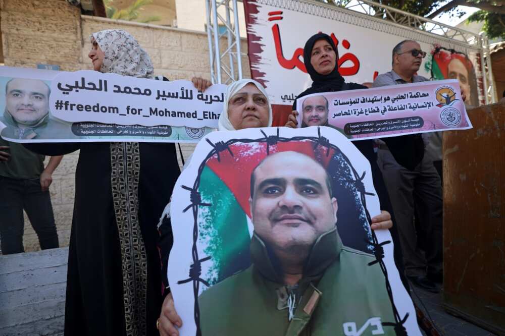 Mohammed Halabi, former Gaza director of World Vision, was sentenced to 12 years in jail on Tuesday for sending cash to Hamas: in this June 2022 photograph his mother holds his portrait in a rally demanding his release