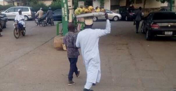 Photo of a visually impaired man who sells banana in Kaduna to train his children in school