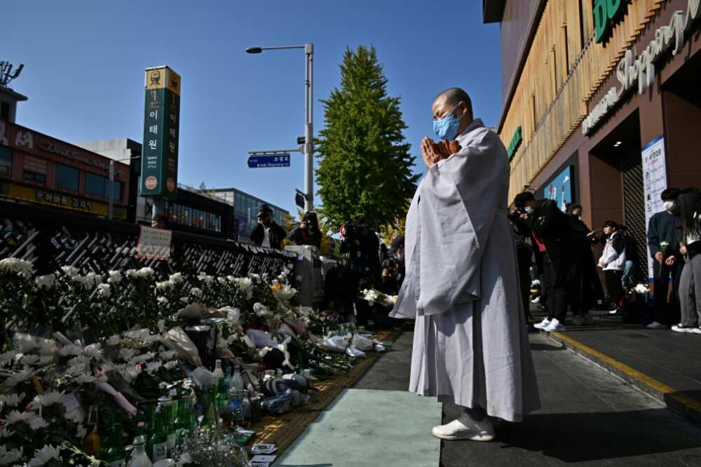 A Buddhist nun prays in tribute to the victims