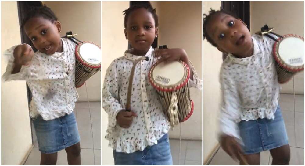 Photos of a little girl playing talking drum.