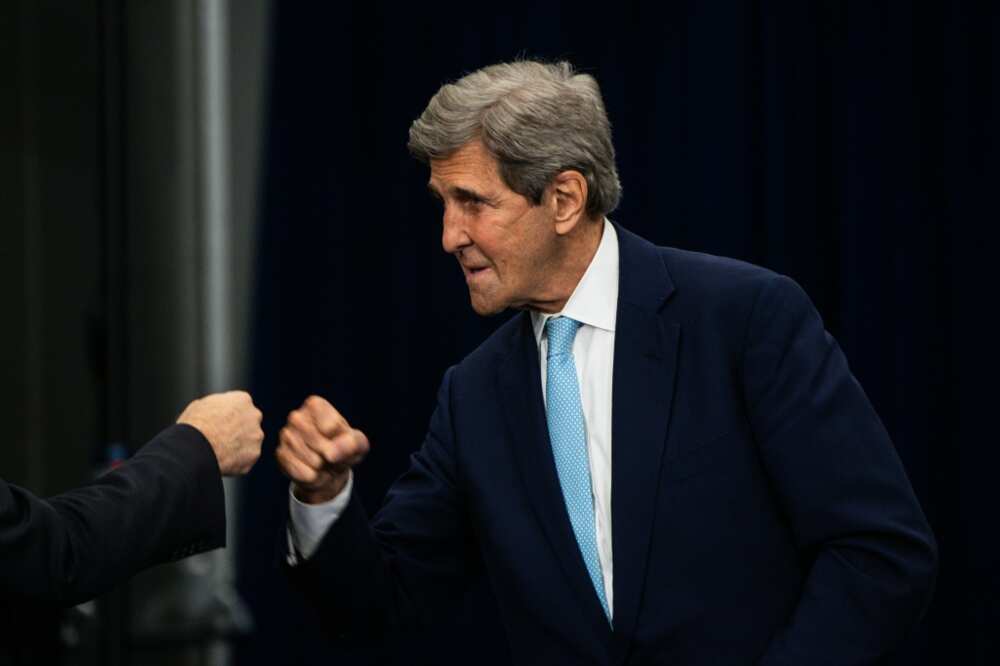 US Special Presidential Envoy for Climate John Kerry fists-bumps a guest at the Summit of the Americas in Los Angeles in June 2022