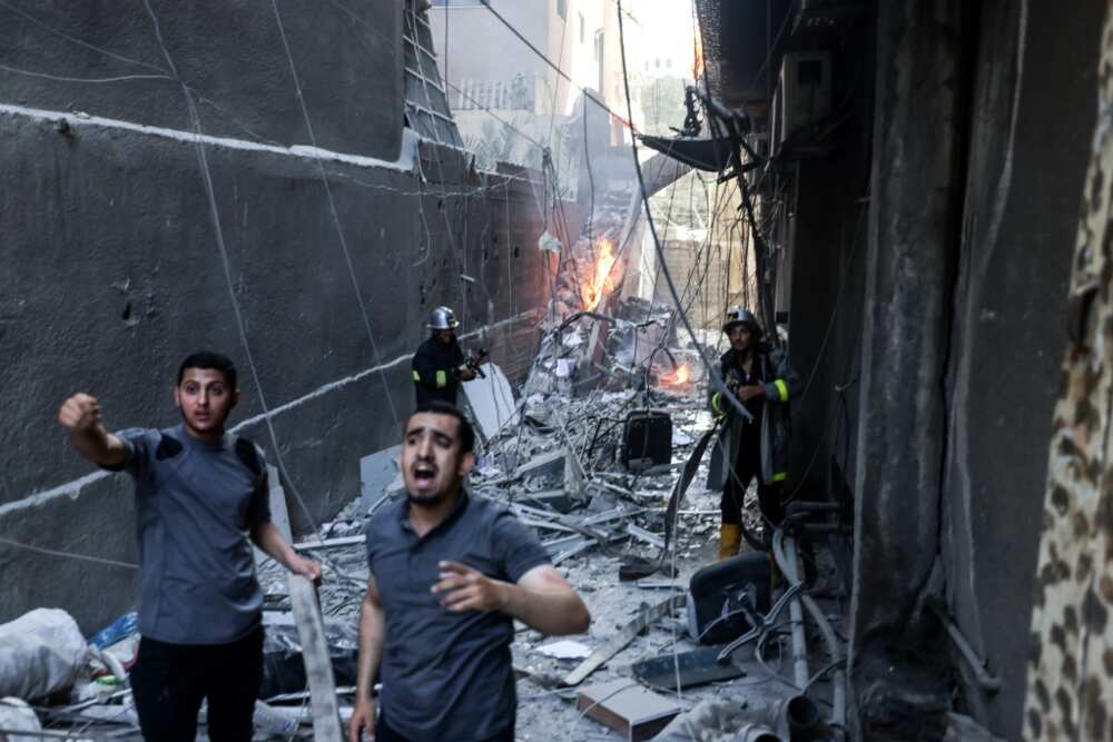 Palestinian firefighters battle a blaze sparked by an Israeli air strike on Gaza City